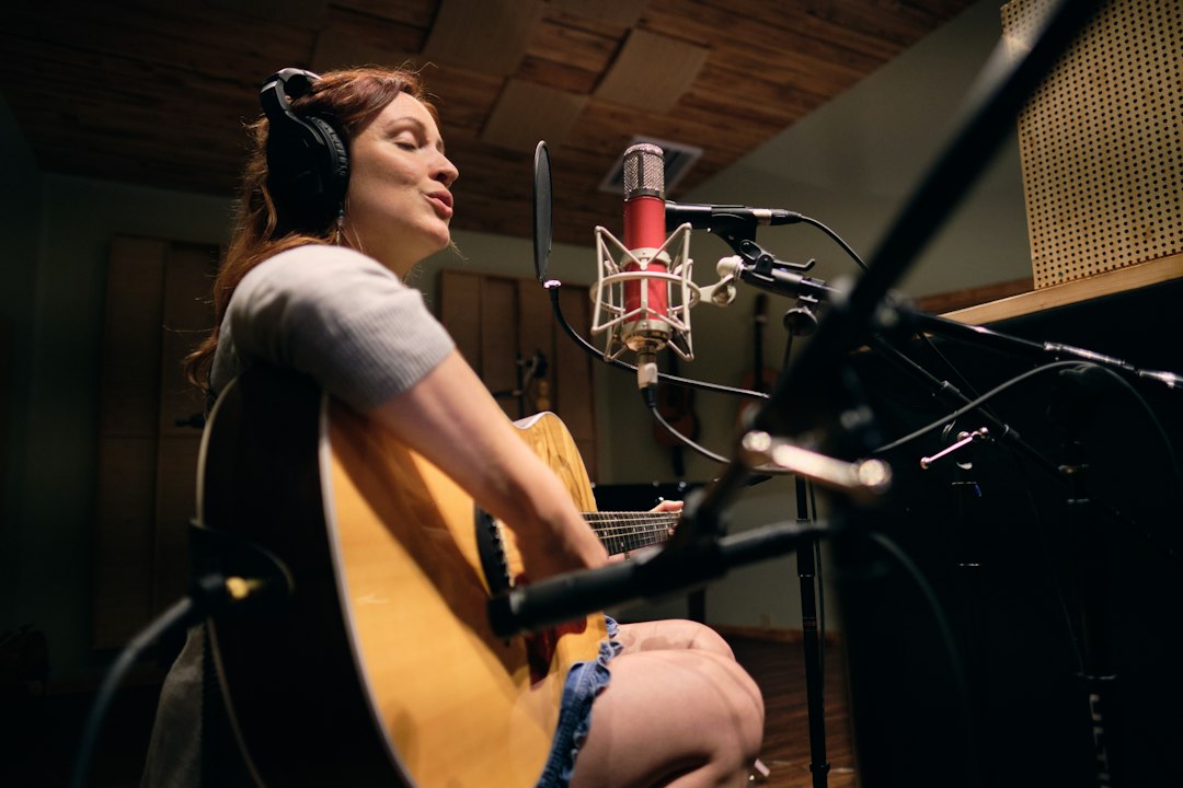 woman-in-gray-shirt-playing-guitar-xo999ogjv6u